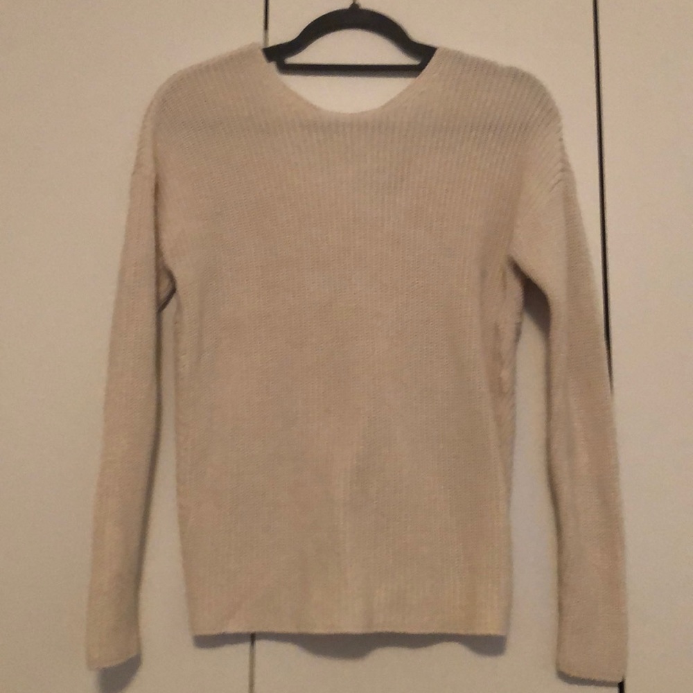 White sweater. Crew neck front, bow on back